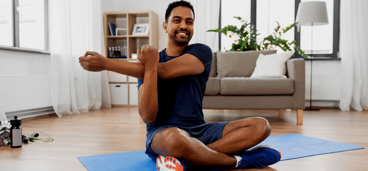 Husband Practicing Self Care By Stretching During COVID19 as Suggested in Relationship Therapy